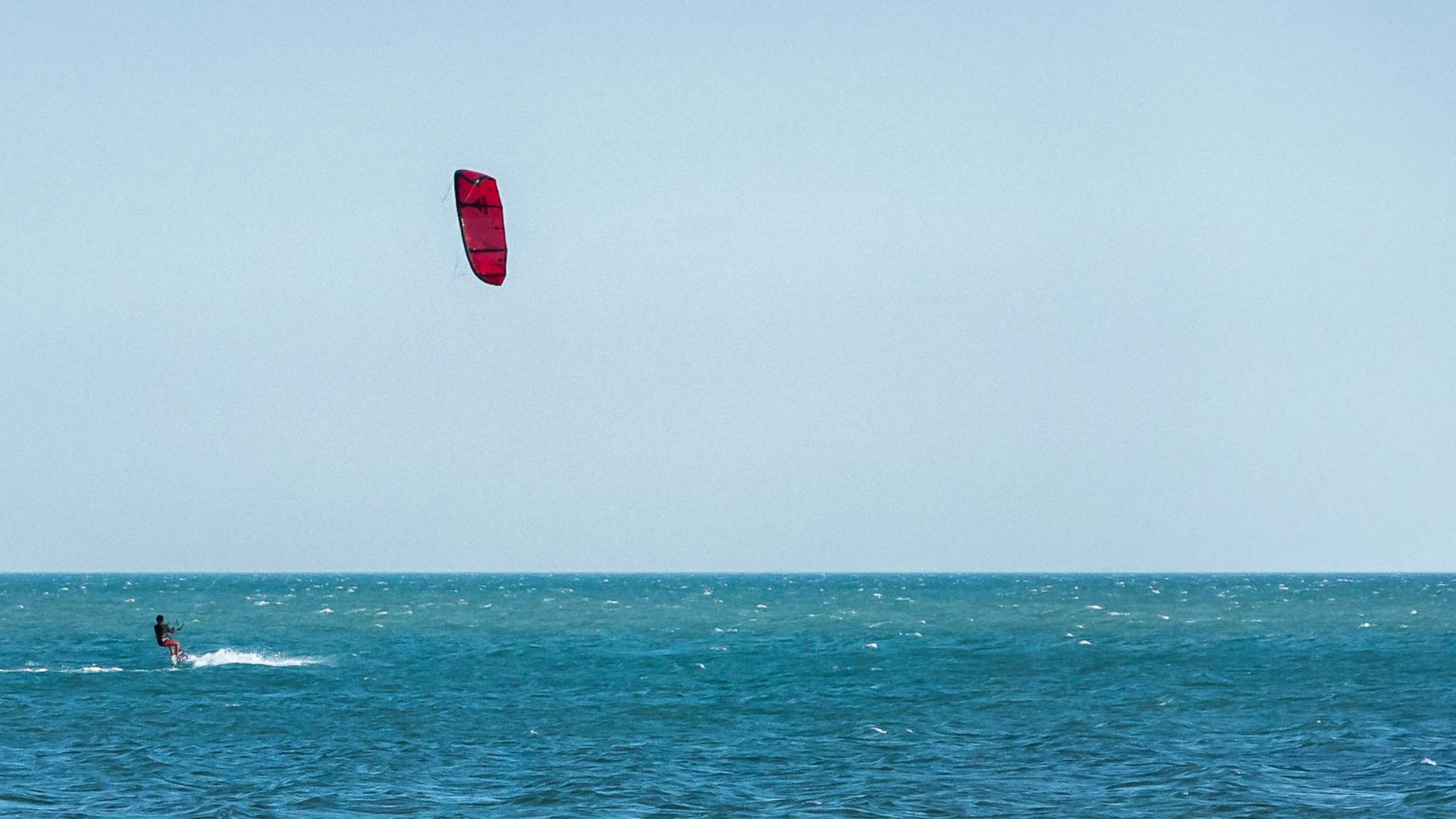 A tourist kite surfing.