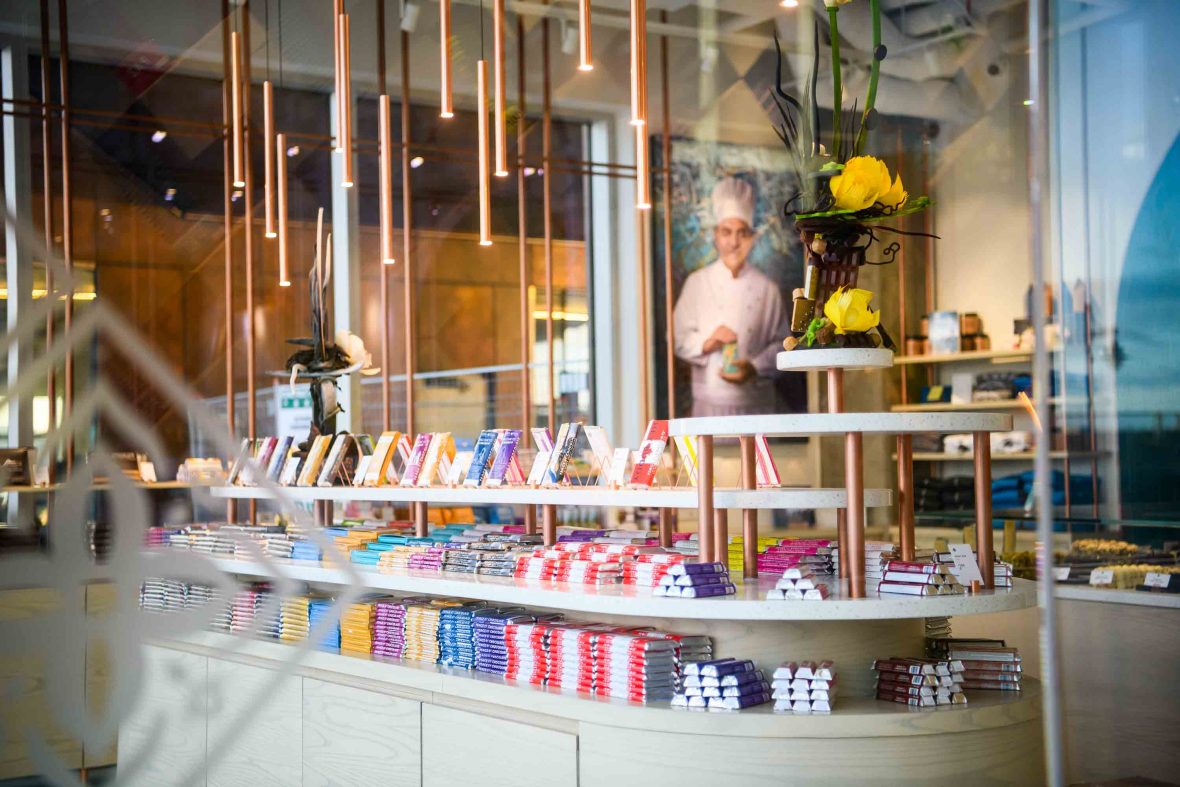 The interior of the Halifax waterfont store with a range of chocolate bars on display and a portrait of Isam Hadhad on the wall in the background.