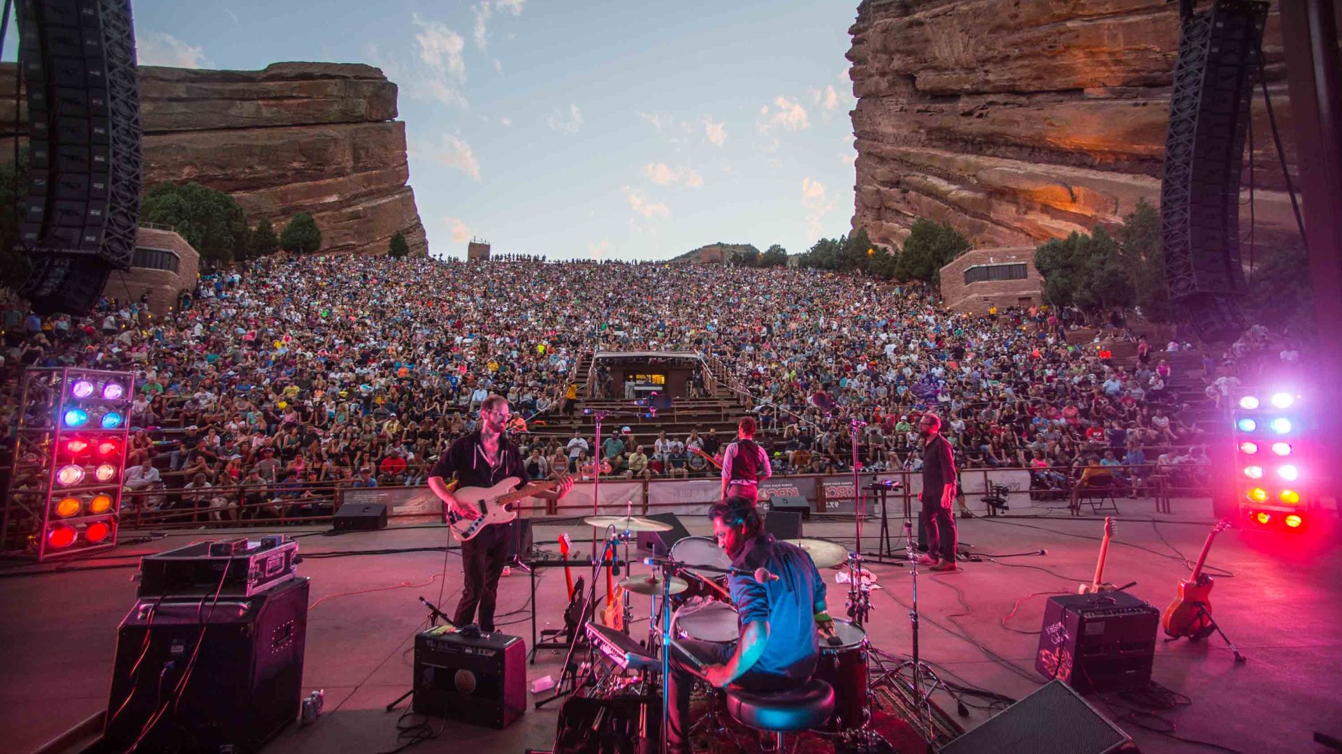 A band plays in front of a huge audience.
